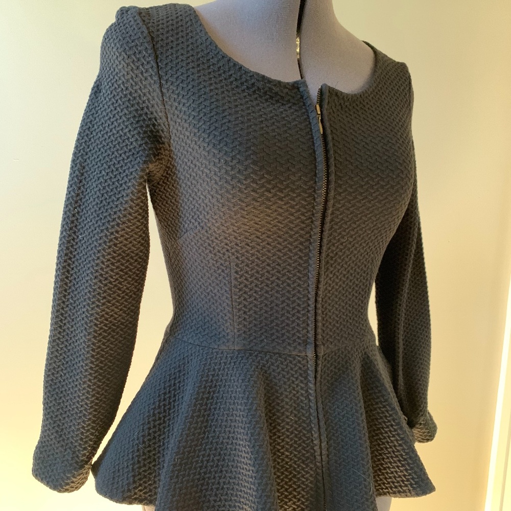 Black zip-front peplum top